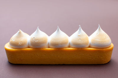 Long lemon tart on brown background