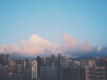 View of cityscape against blue sky