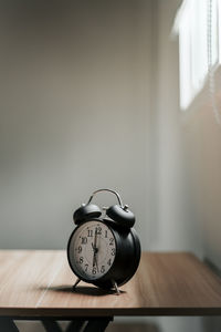 Close-up of clock on table