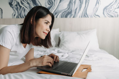 Young woman using laptop at home