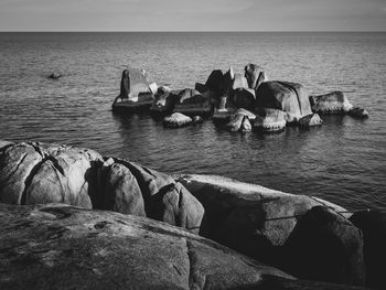 Panoramic view of rocks on sea against sky
