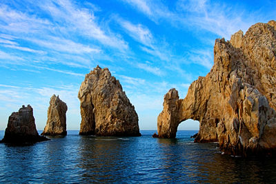 Panoramic view of rock formation in sea against sky