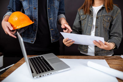 Midsection of woman using mobile phone