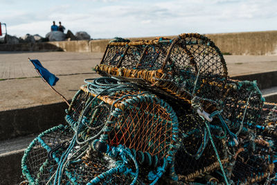 Fishing boat moored at harbor against sky