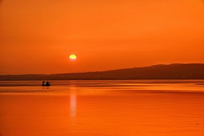 Scenic view of lake during sunset