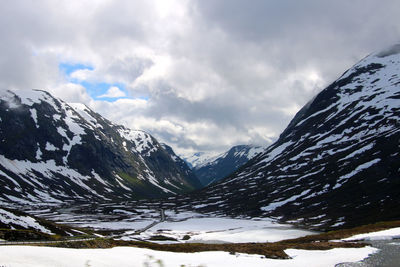 Scenic view of snow covered mountains against sky