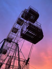 Low angle view of crane against sky during sunset