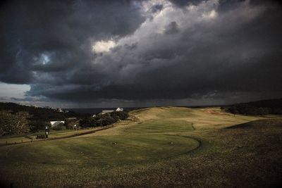 Scenic view of landscape against dramatic sky