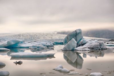 Scenic view of frozen lake against sky during winter