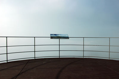 Low angle view of railing against sky