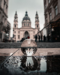 Reflection of building on water in city