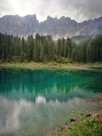 Scenic view of lake by mountains against sky