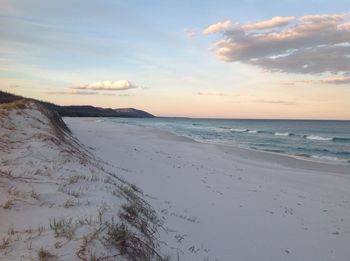 Scenic view of beach against sky during sunset