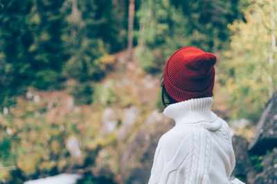 One with nature. back view of unrecognizable woman looking to forest, female in white sweater