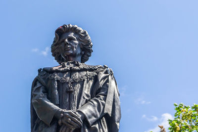 Low angle view of statue against blue sky