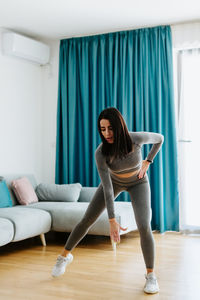 Full length portrait of woman at home