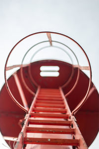 Directly below shot of ladder against clear sky