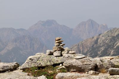 Stack of rocks against mountain range