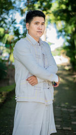 Man looking away while standing at park