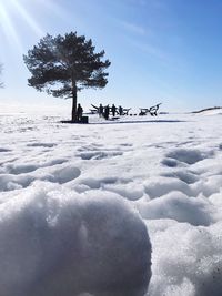 Scenic view of snow covered field against sky