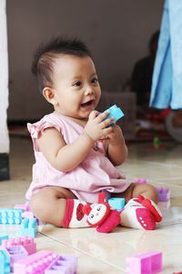 Cute baby boy sitting at home