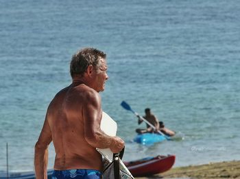 Close-up of shirtless man on beach