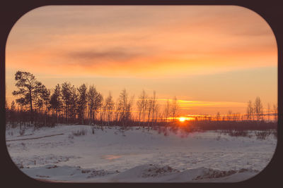 Scenic view of snow covered landscape during sunset