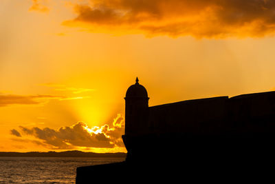 Dramatic sunset with silhouette of a castle.