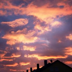 Low angle view of silhouette building against sky during sunset