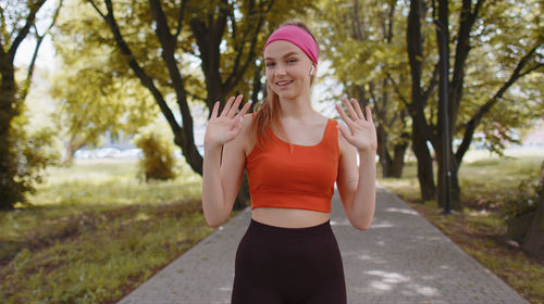 Portrait of young woman standing in park