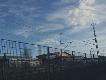 Low angle view of power lines against sky