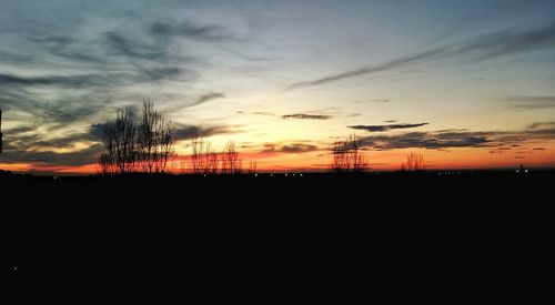 Silhouette landscape against sky during sunset