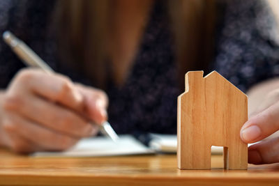 Cropped image of person holding table