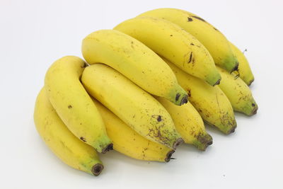 High angle view of yellow slices over white background