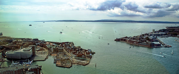 High angle view of sailboats moored in sea against sky