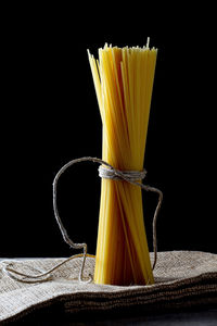 Close-up of yellow served on table against black background