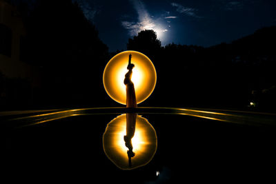 Close-up of yellow lights against trees at night