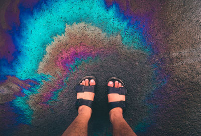 Low section of person standing on rainbow