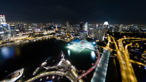 High angle view of city lit up at night