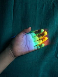 Close-up of hand holding multi colored lights