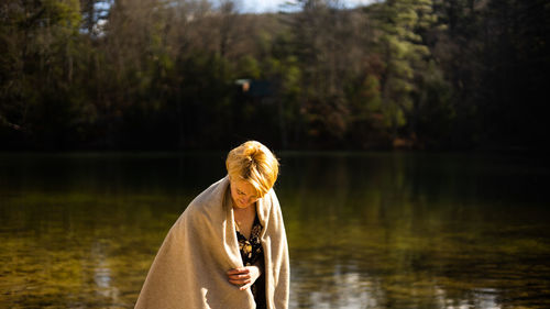Side view of woman standing in lake