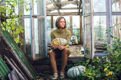 Portrait of young woman sitting outdoors