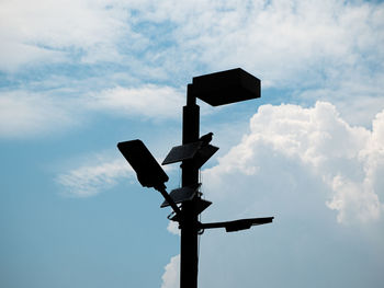 Low angle view of telephone pole against sky