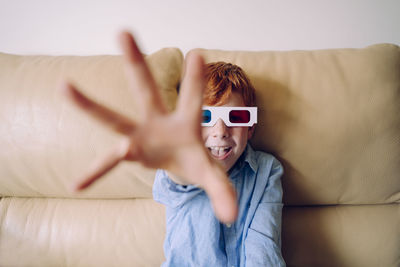 Portrait of boy gesturing while wearing 3-d glasses