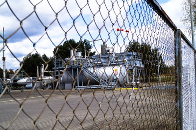 Close-up of chainlink fence against factory