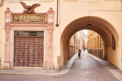 Rear view of man walking in tunnel