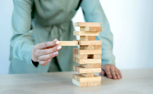 Midsection of man playing with toys on table