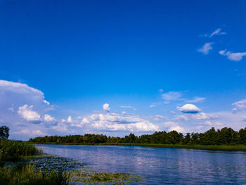 Scenic view of lake against blue sky