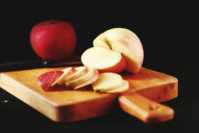 Close-up of apple on table against black background