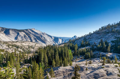Scenic view of mountains against blue sky